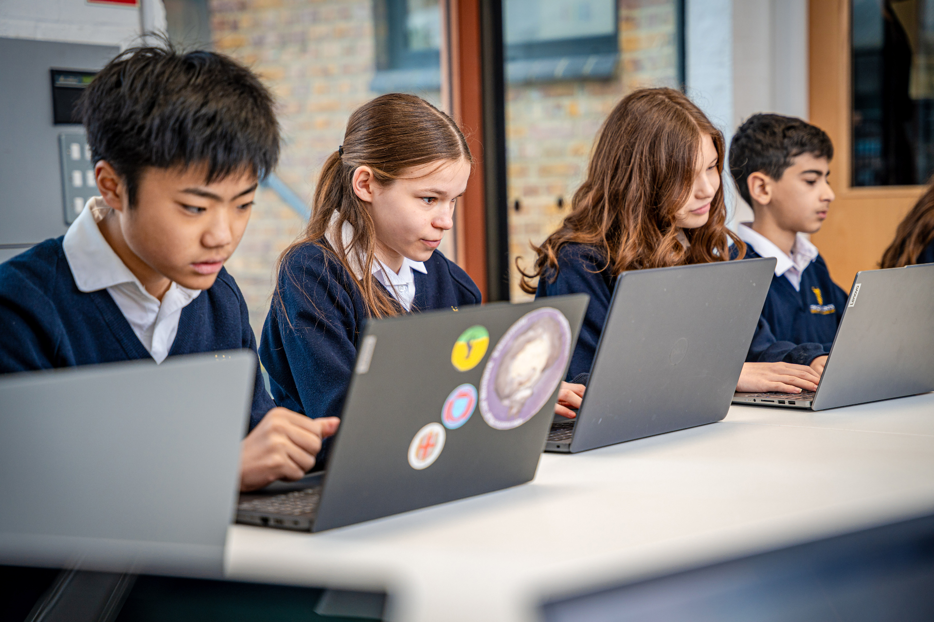 Year 7 students working on laptops in a Chalfonts classroom